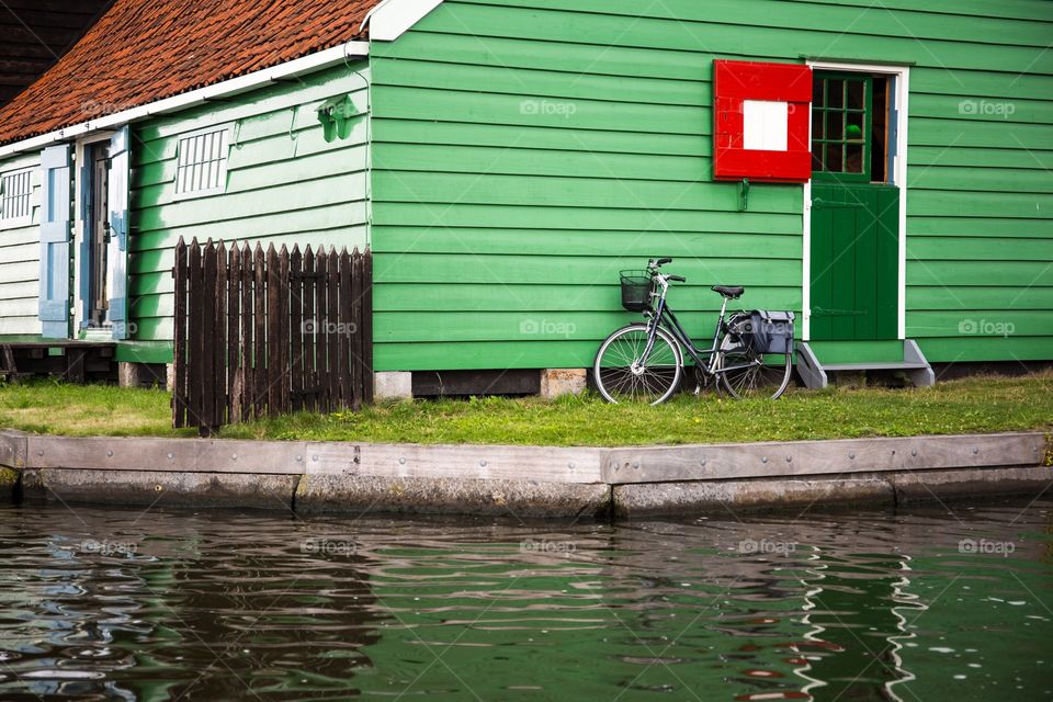 cozy yard with a green house and a bicycle