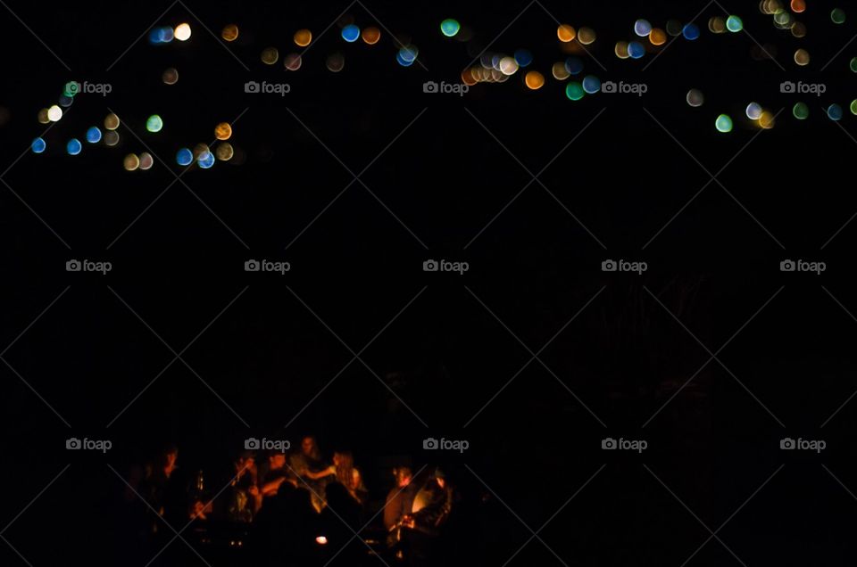 Campfires at a mission trip in Mexico, with the lights of the local houses creating a bokeh backdrop