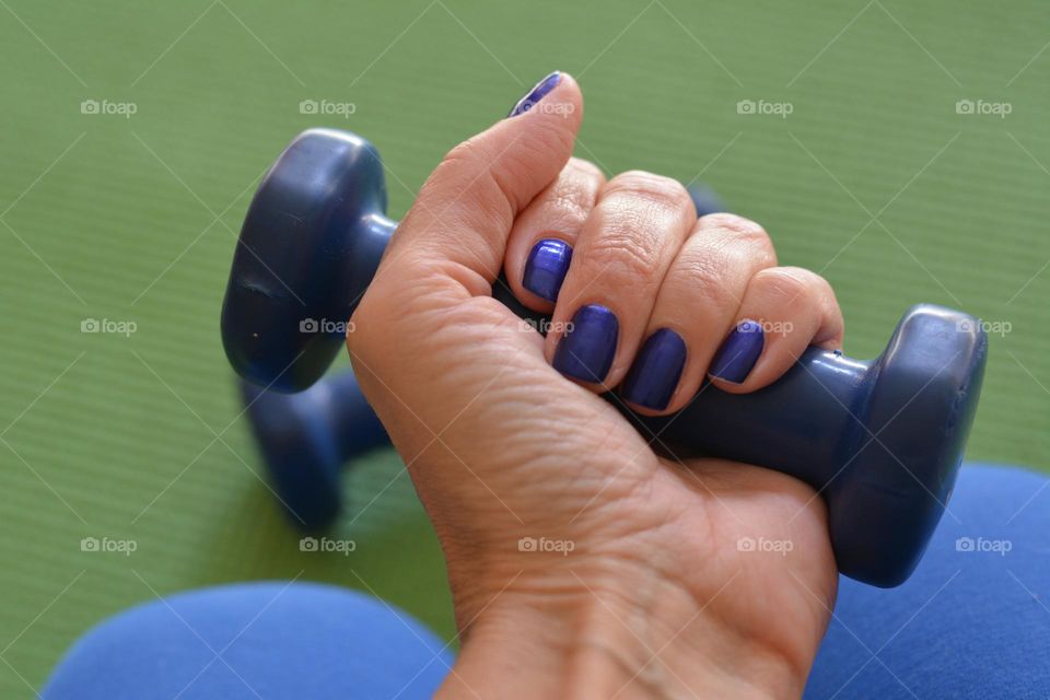 sport time dumbbell in the female hand