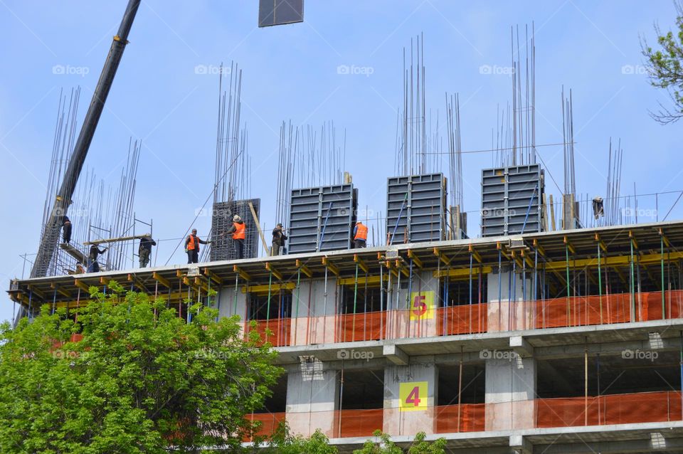 construction area with working assemblers. installation of rectangular formwork for pouring concrete wall slabs.