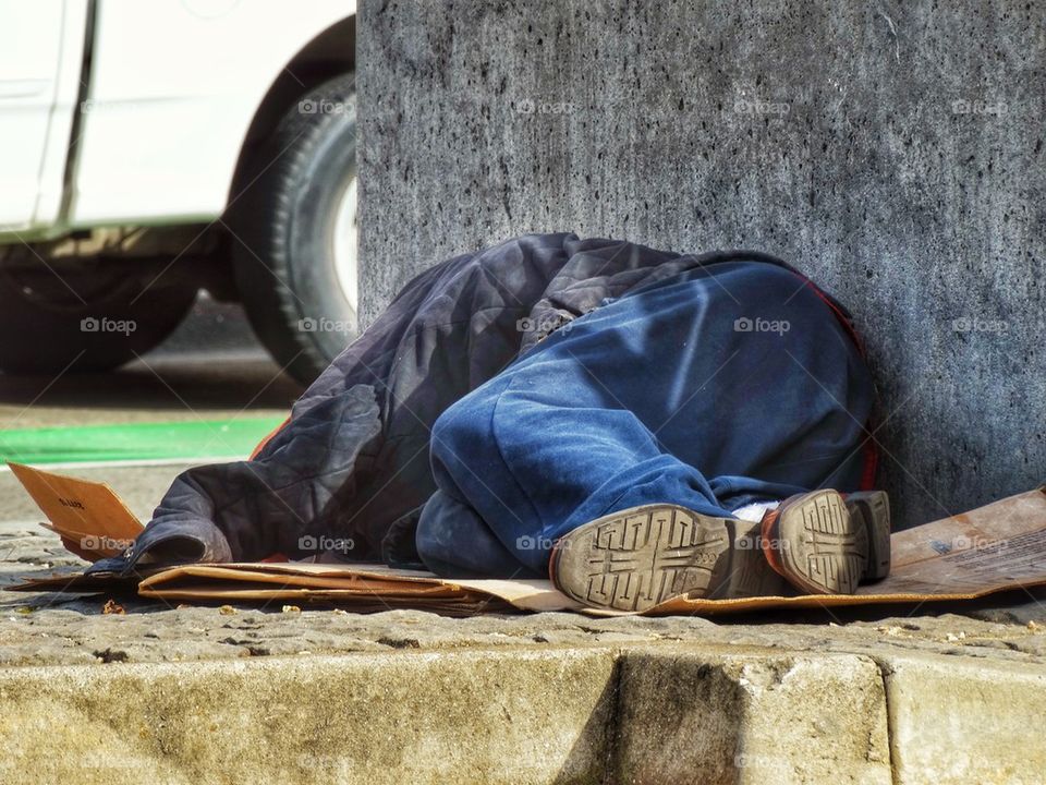 Homeless Person Asleep In The Street. Poverty In America
