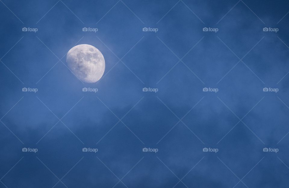 Moon on cloudy twilight sky background