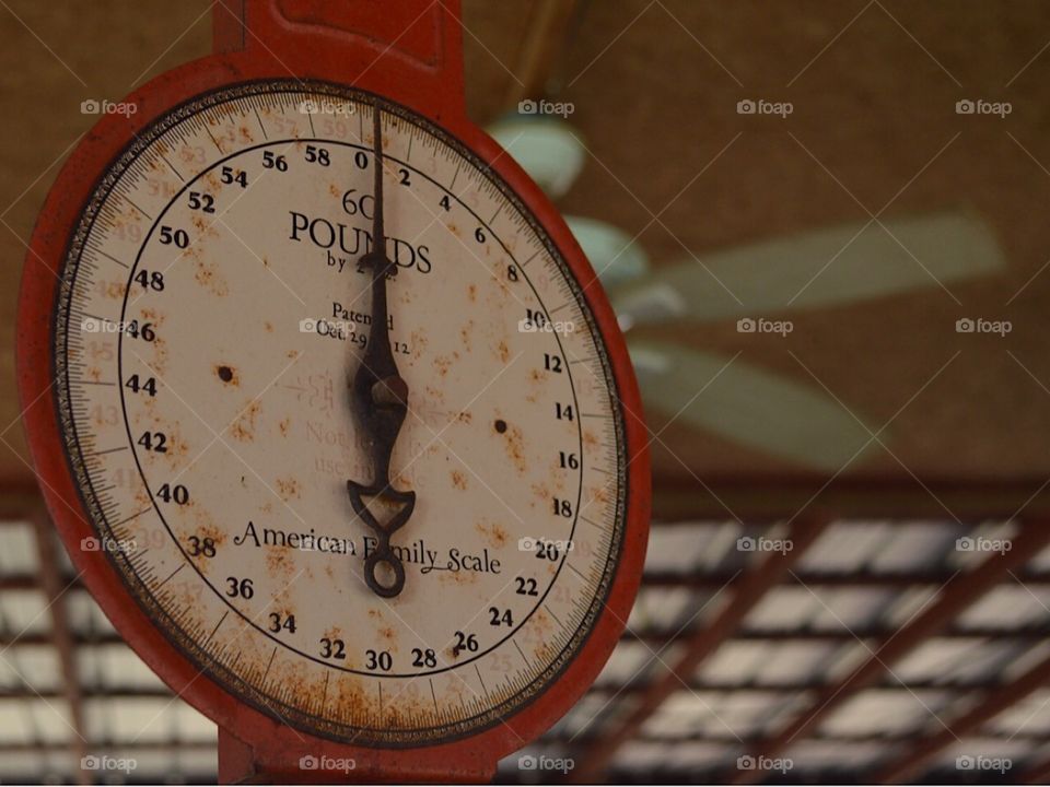 A very old scale hanging in out vegetable stand 