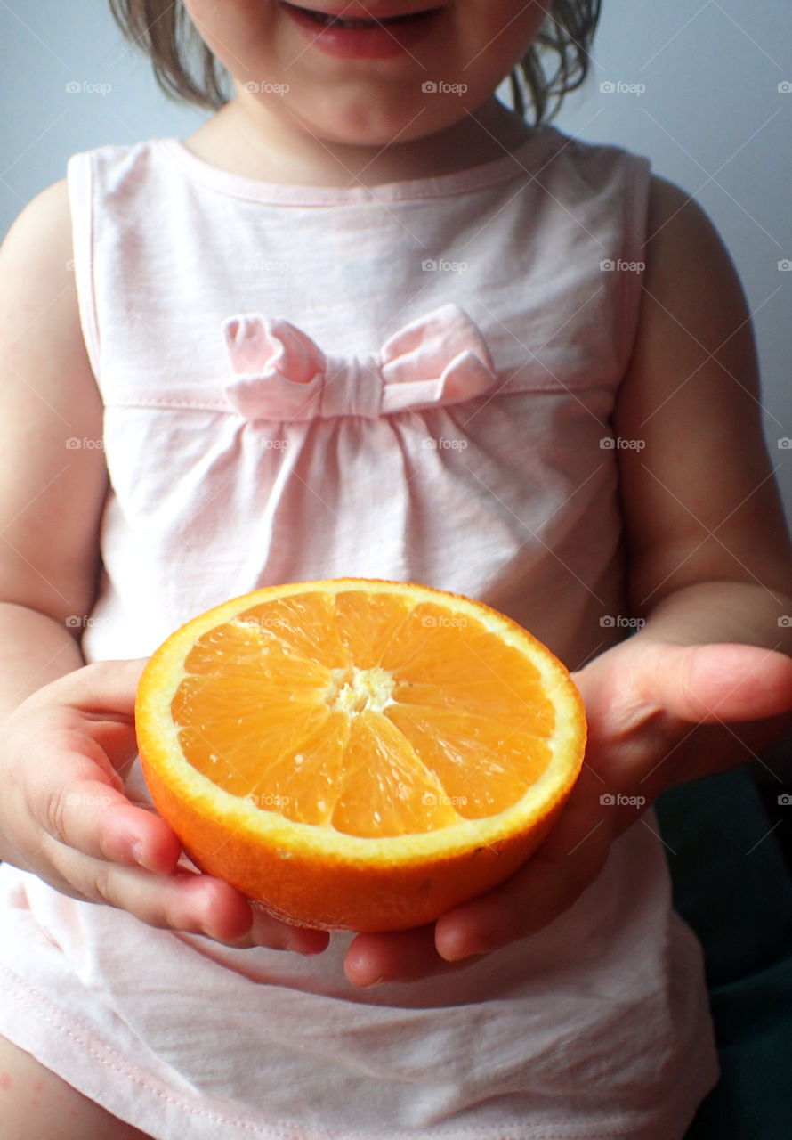 Kid holding orange
