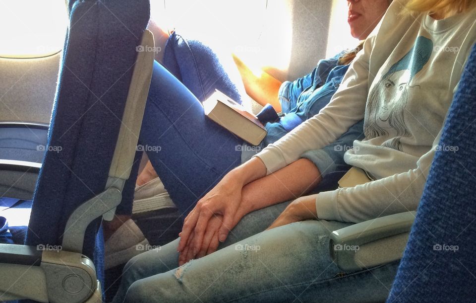 Girls friendship. . I saw this two girls on a plane. They look like lovers. My smart phone always with me. I hope I was able to make a smart shot.