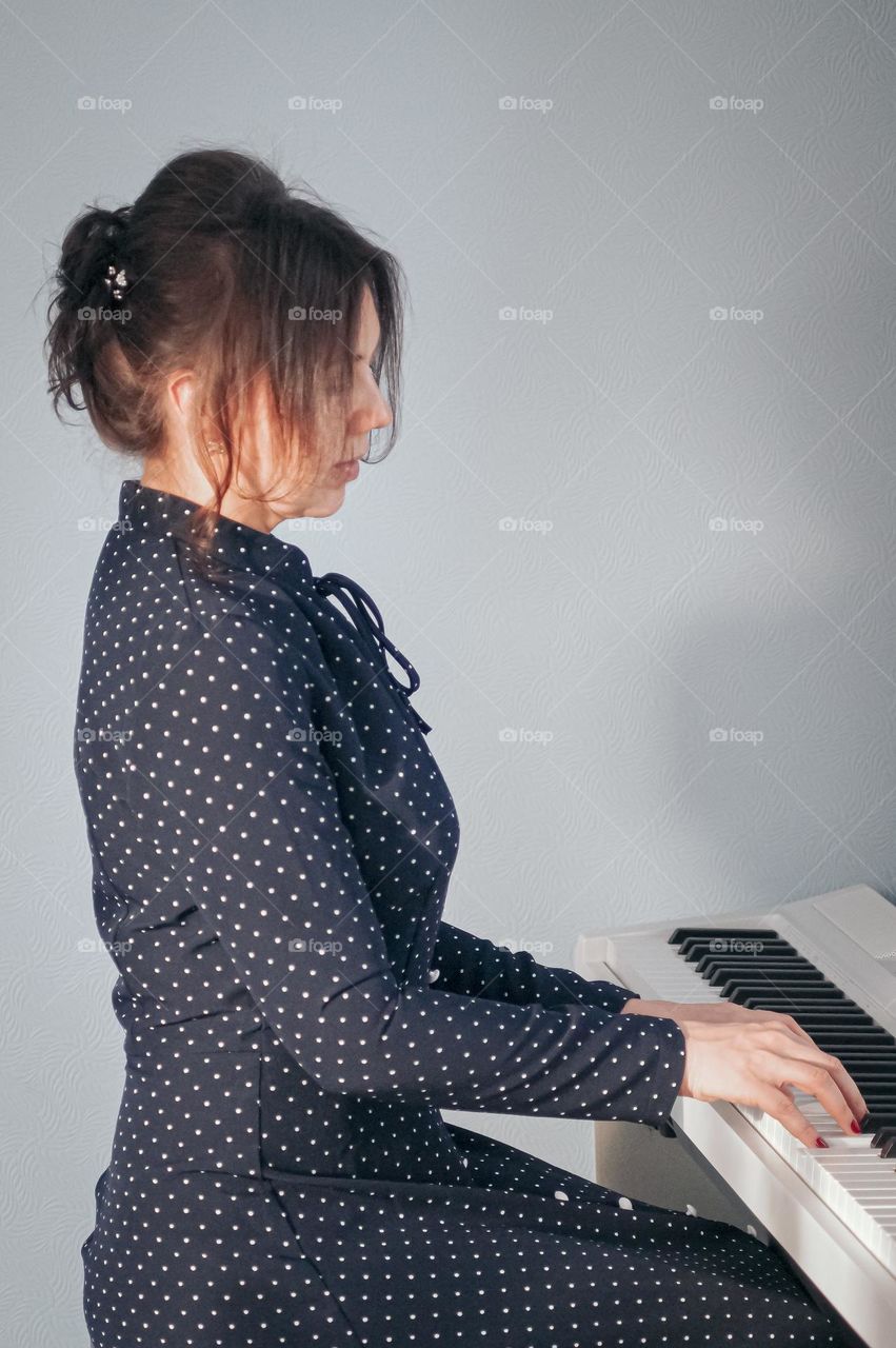 Very beautiful girl playning the piano