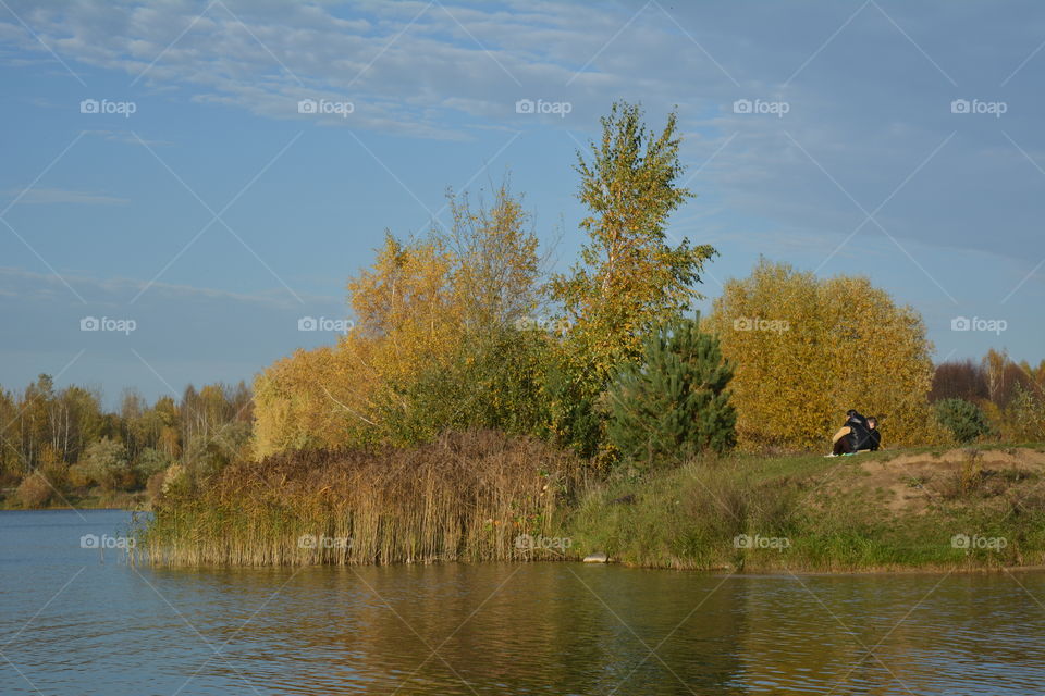 lake beautiful nature landscape and family resting autumn time blue sky background