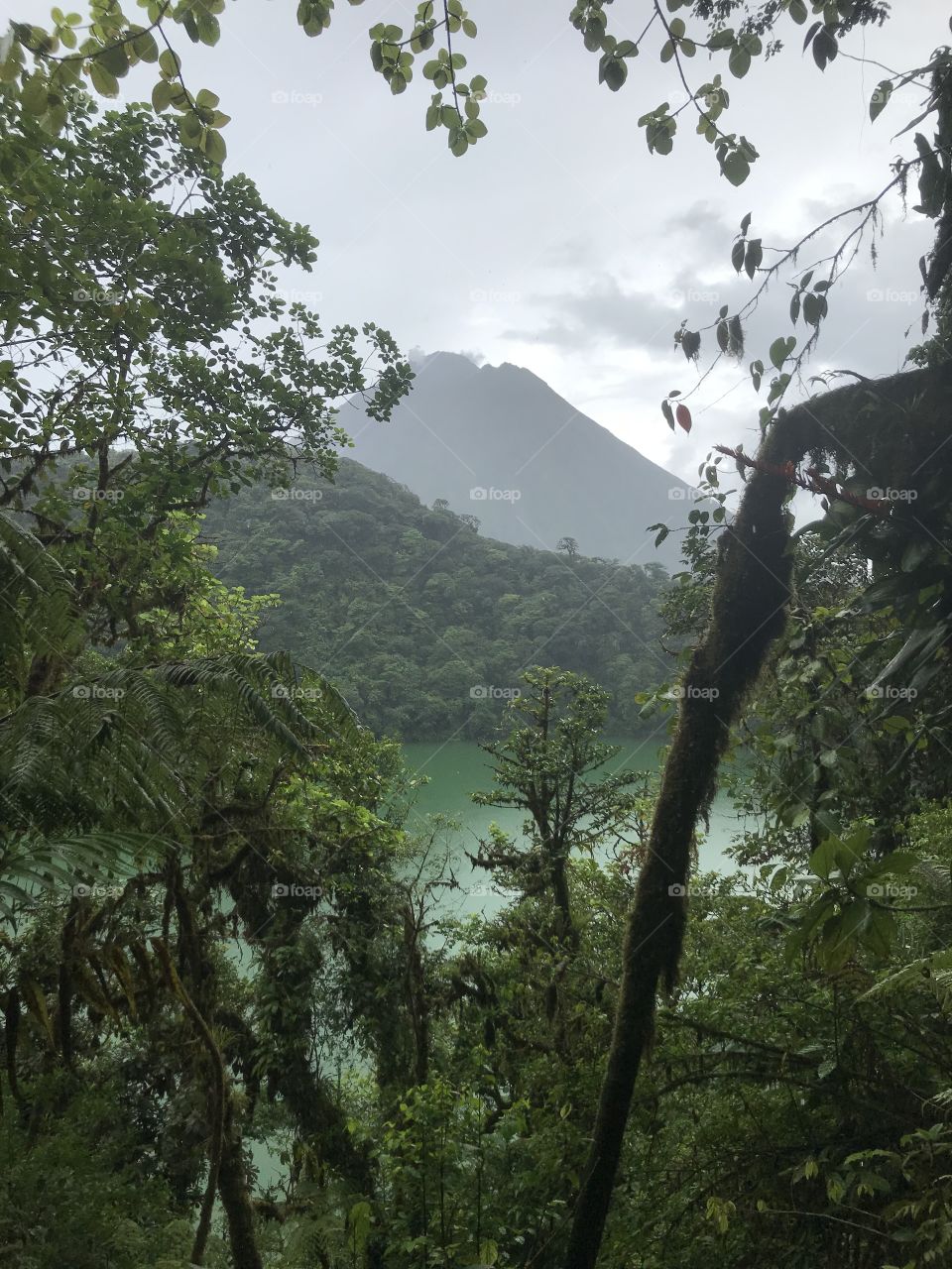 At the top of an inactive volcano overlooking its crater filled green lagoon with the active Arenal volcano in the background! It's amazing the natural beauty's of life and everything they have to offer!