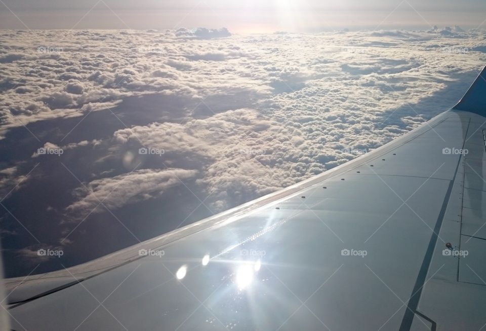 Flying in a plane above Clouds. Flying above the Clouds