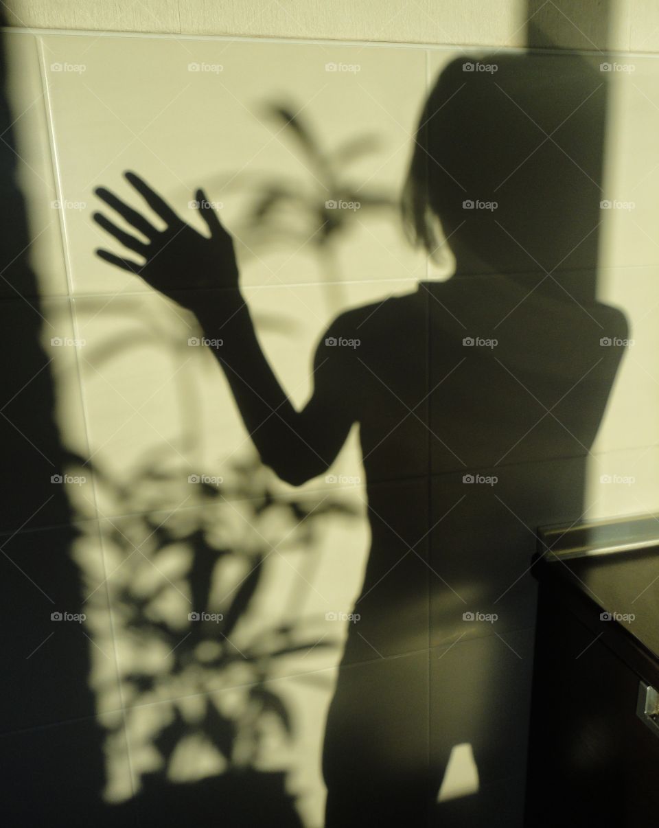 shadows girl  and hand on a wall in the room, beautiful texture abstract background