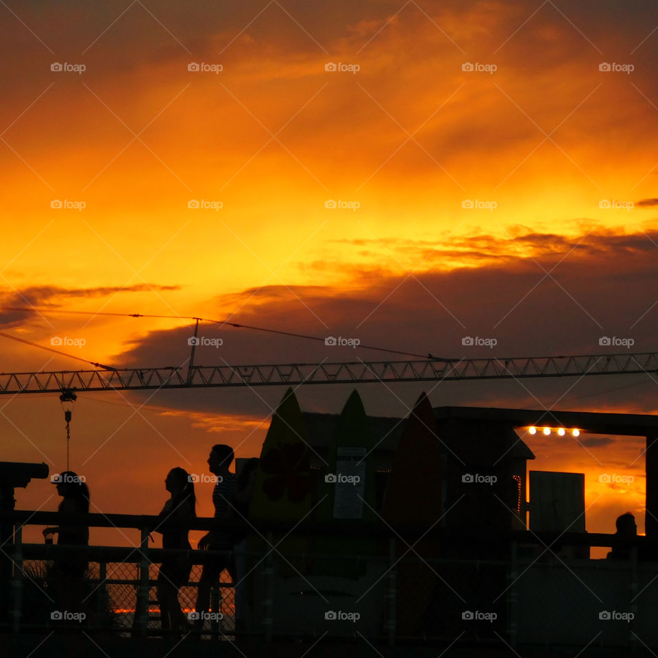 People strolling across the pier to catch a glimpse of this spectacular sunset over the Gulf of Mexico!