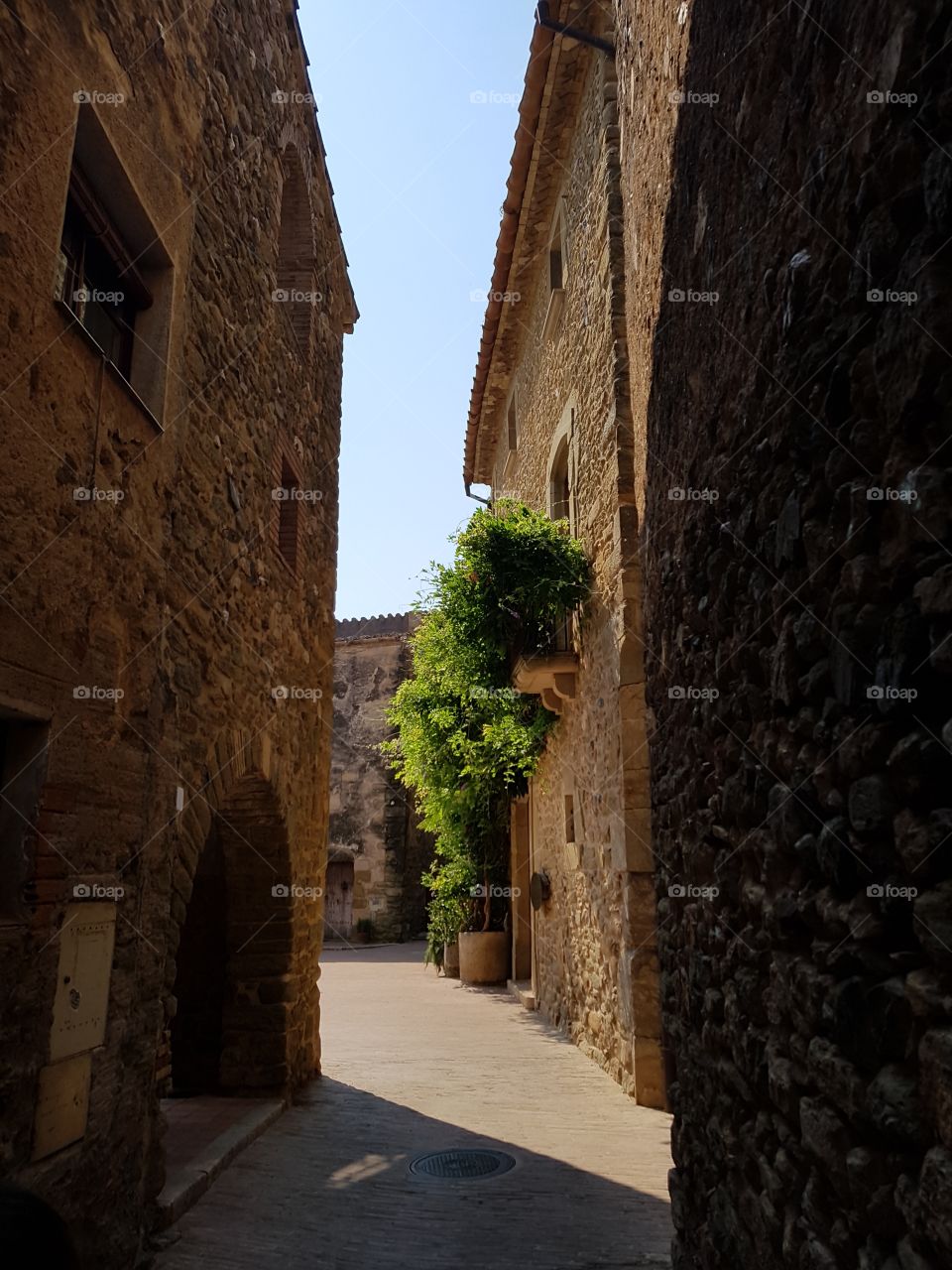 shadow and sun in a narrow street at Monells town, Catalonia