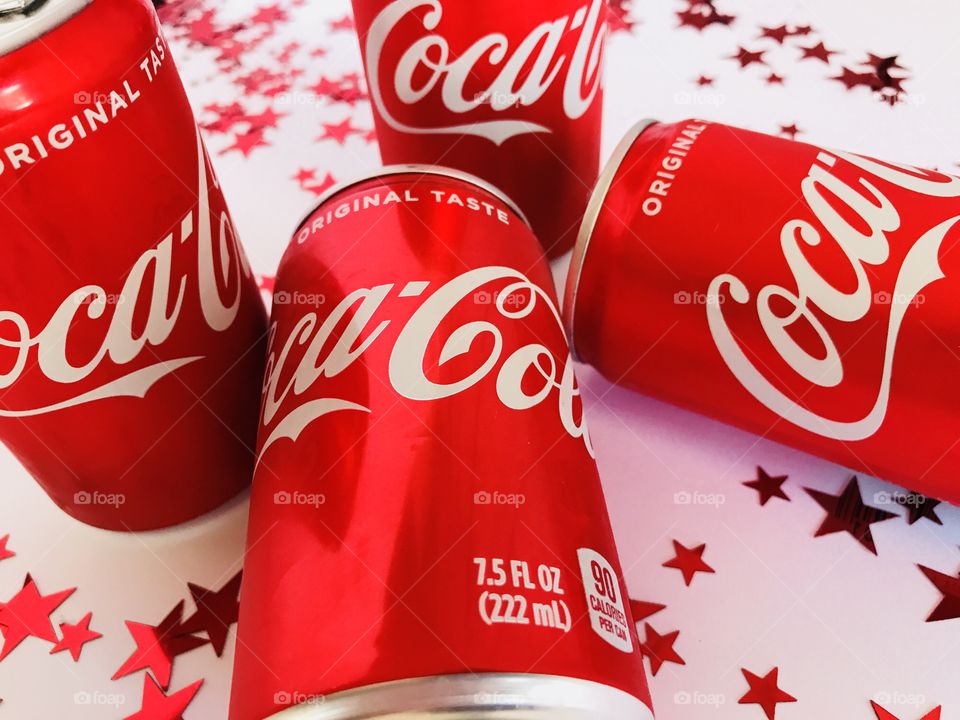 Coca Cola on a white background with red stars