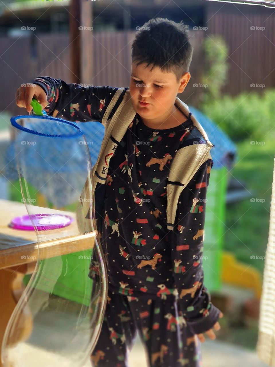 child making huge soap bubbles