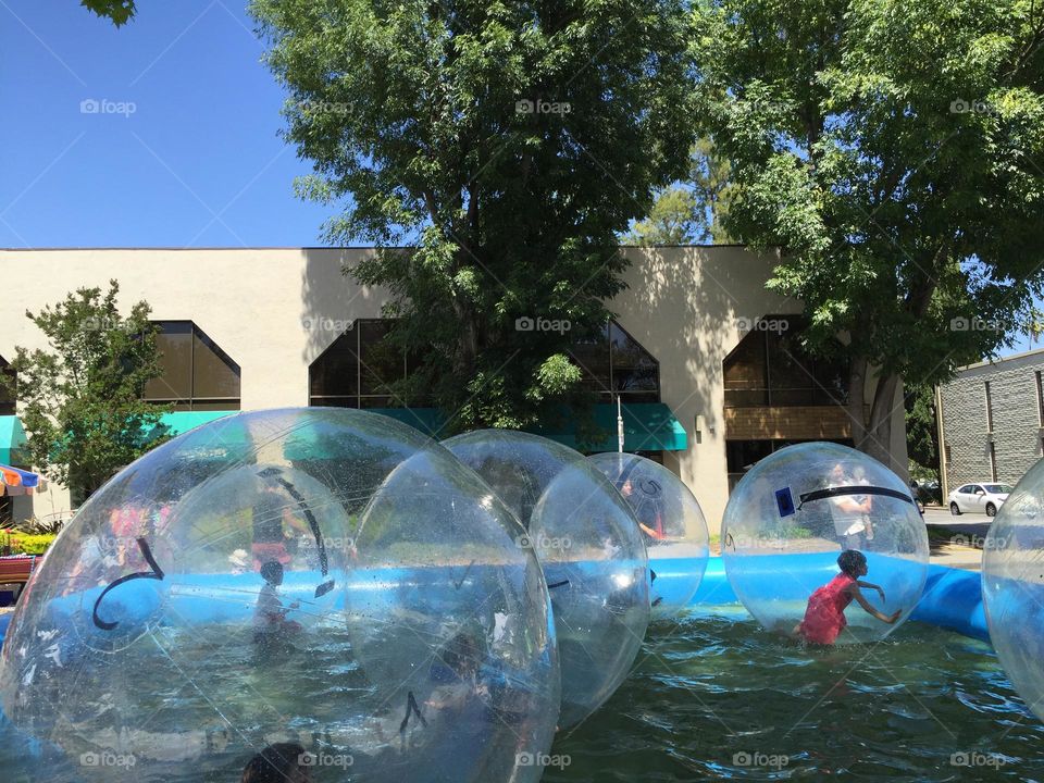 Kids enjoying a temporary water feature during summer.