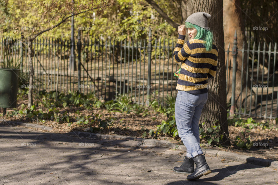Alternative girl with green hair walking in the park