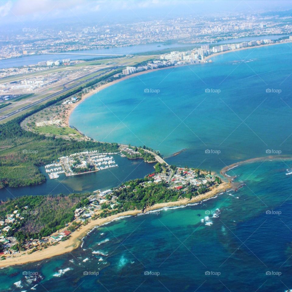 Puerto Rico east side. View of Puerto Rico Island includes beach, open ocean, boat park, airport, typical foodie, culture and some metropolitan buildings. You can appreciate Luis Muñoz Marin AirPort through a refresh viewable of east side coast. 
