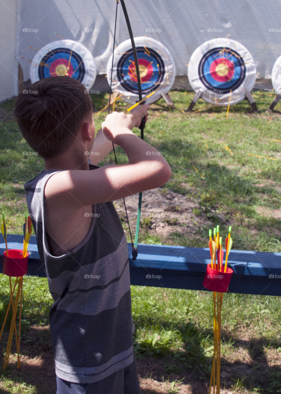 Archery, Boy shooting arrow at a target