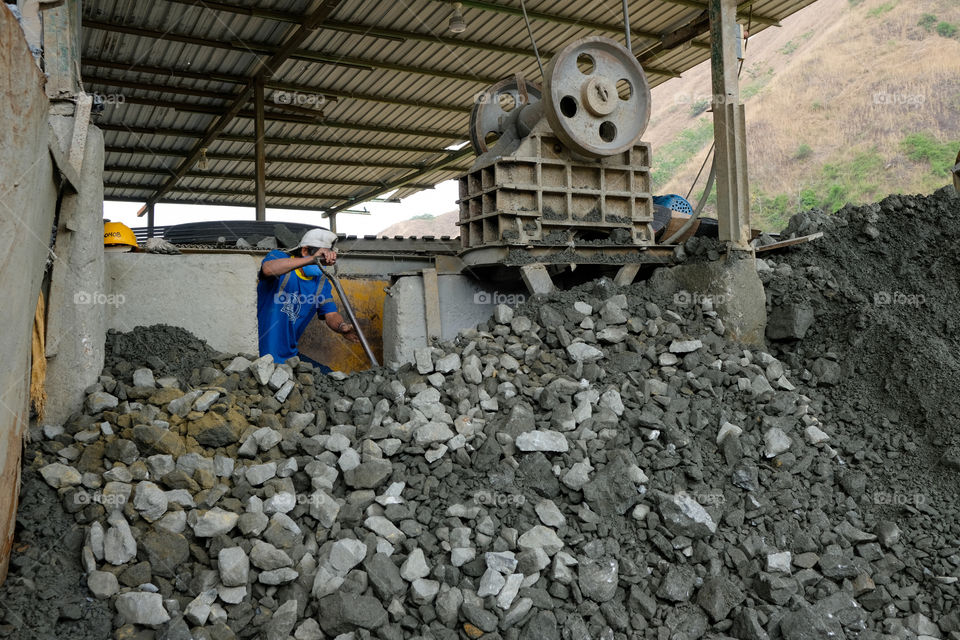 Person working with minerals in mill