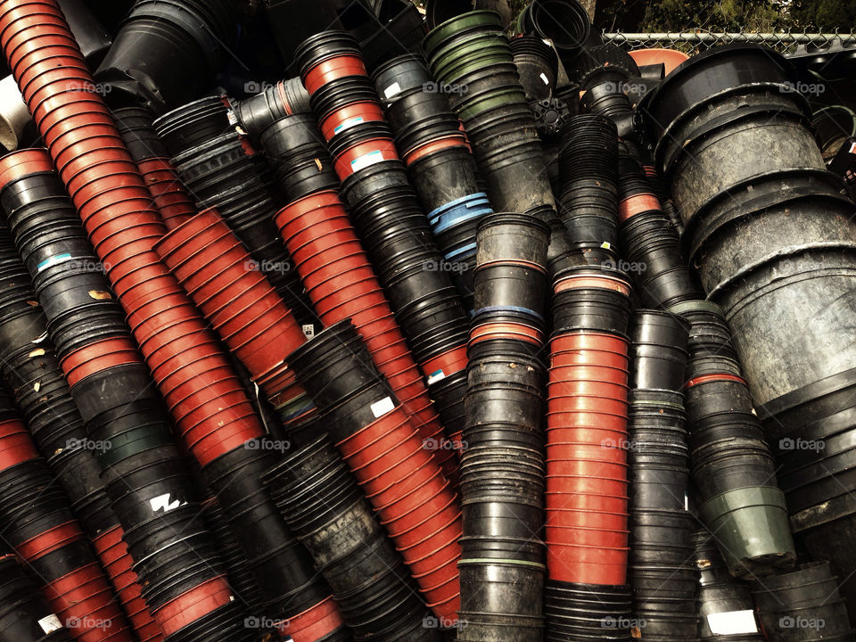 Thousands of stacked plastic pots at a garden nursery