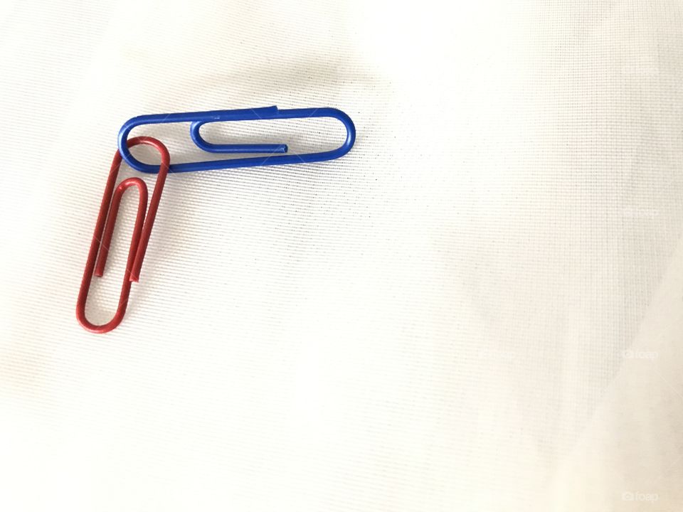 Red and blue paper clips locked