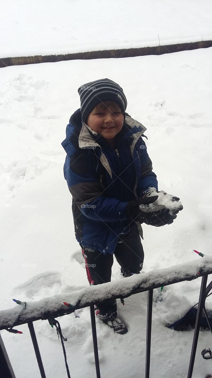 My baby boy having fun in the snow. Looks like he’s forming a snowball 😄
