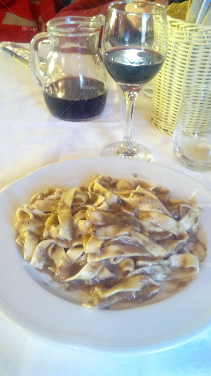 tagliatelle al ragù di capriolo, tagliatelle with venison sauce. red wine for drink, thanks!