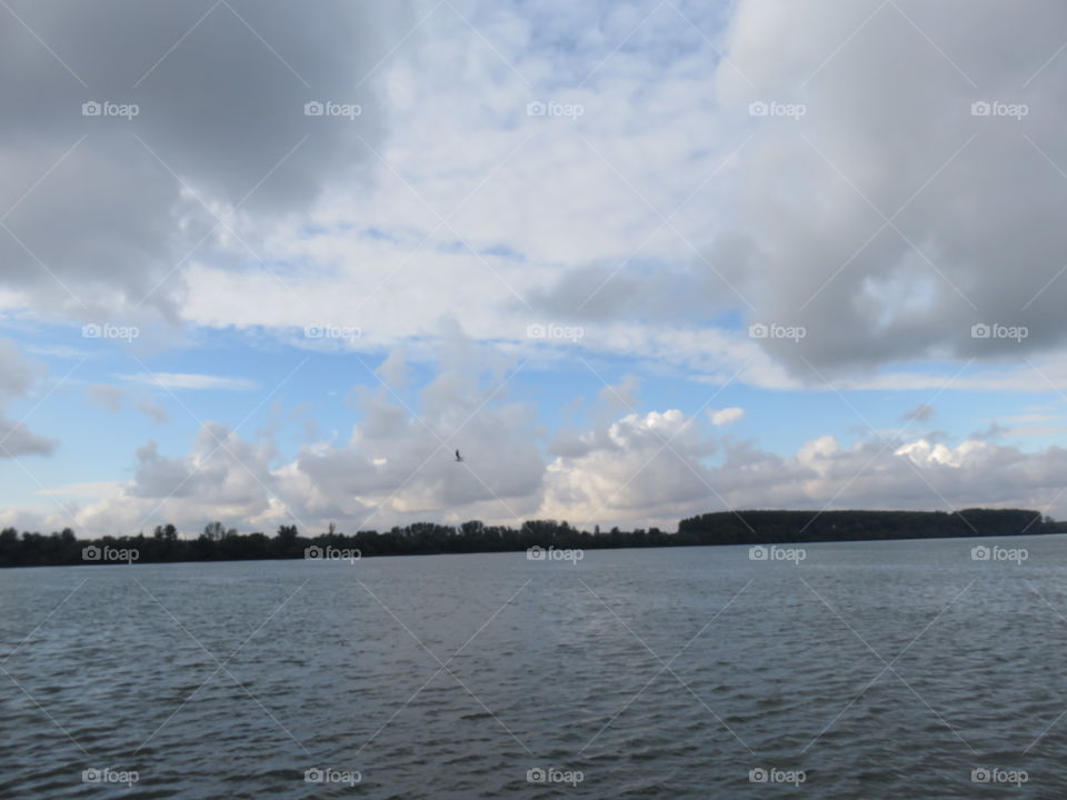 Cloudy sky above the River in afternoon autumn 2019