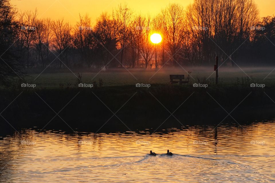 Beautiful Winter Sunset with eerie low fog 