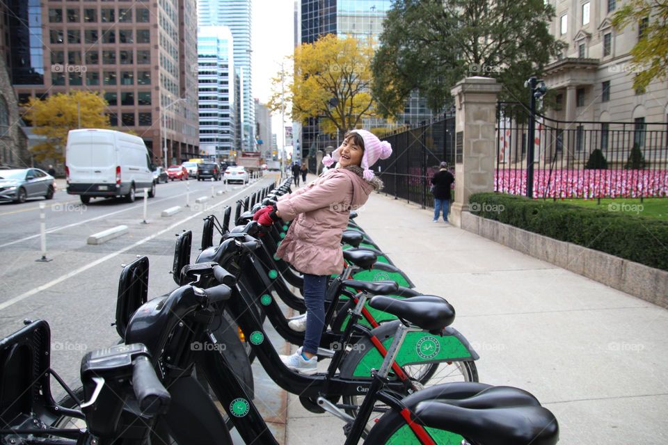 Happy child on a city bike