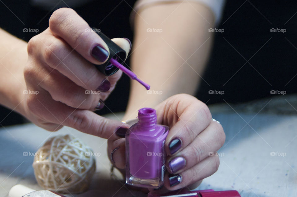 Girl paints nail varnish