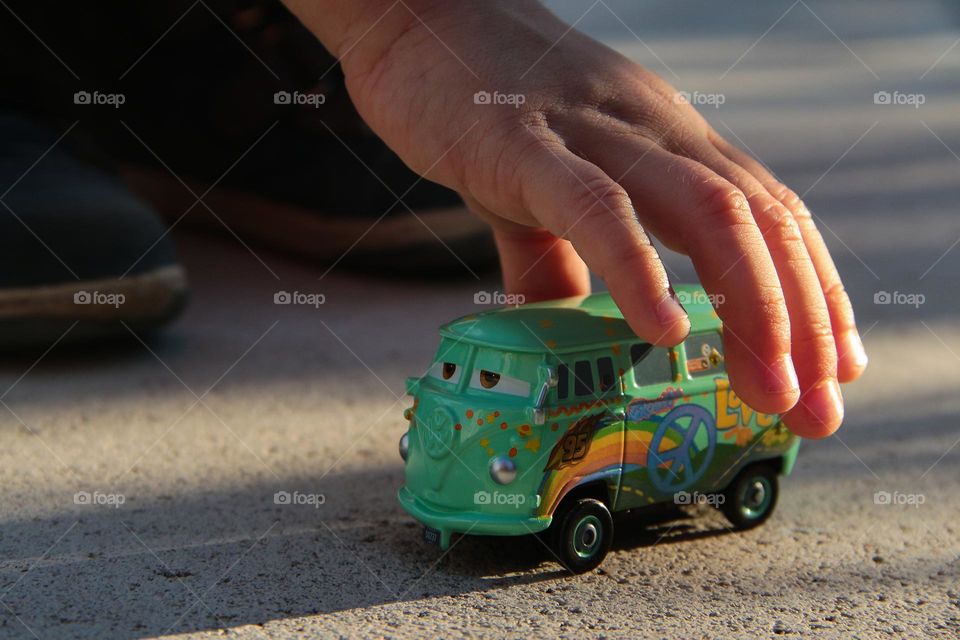 Boy's hand and a toy car