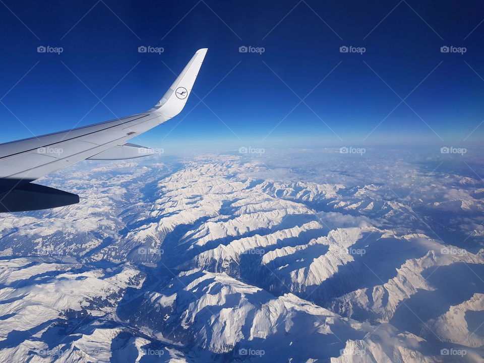 Lufthansa Airbus plane flying over the alps