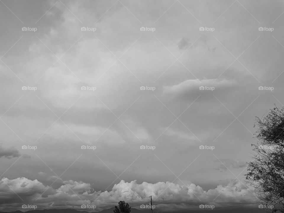 A black and white photo of cloudy skies. 
