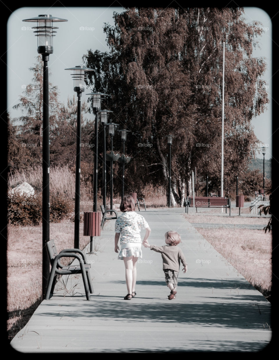 Older sister with her little brother on the walk