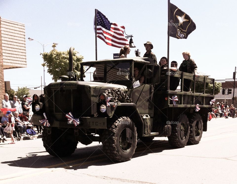 Military Truck in parade. Military men in large truck taking part in Memorial Day Parade. 