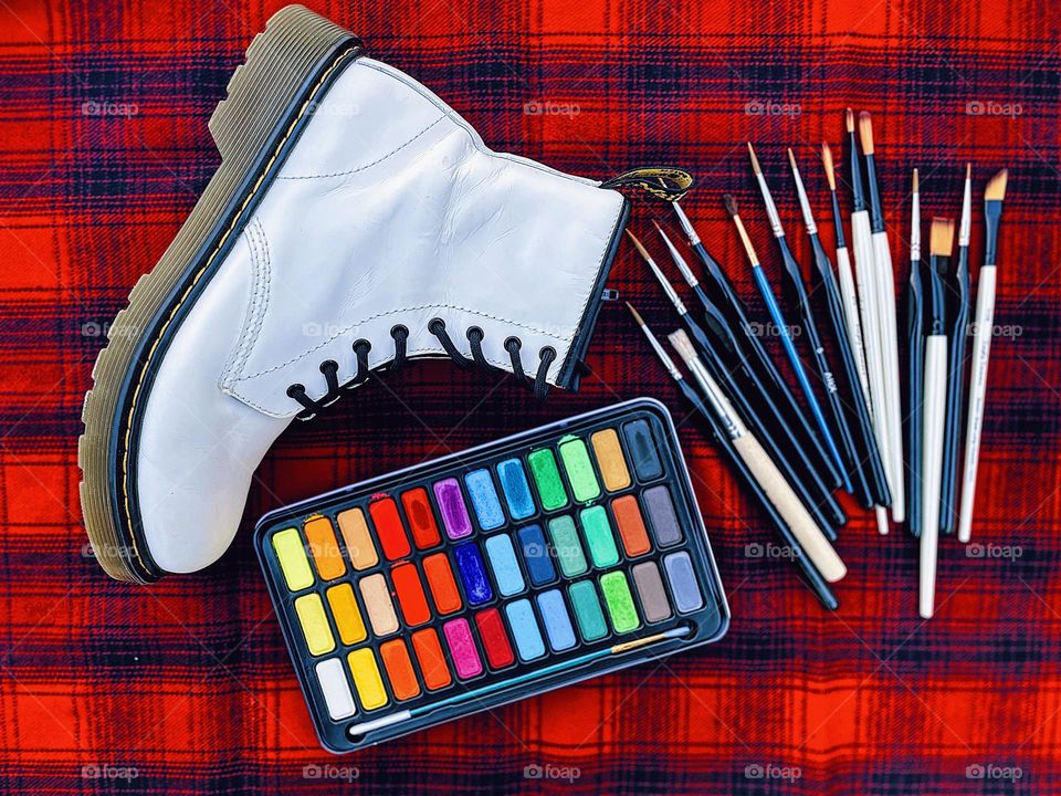 White Doc Marten Boot with art supplies, Artist wears Dr. martens, Docs and Art, DMs and painting supplies, creative painting and boots, punk and painting, creativity in boots, artists and Doc Martens, classic artistic boot, creative process with DMs