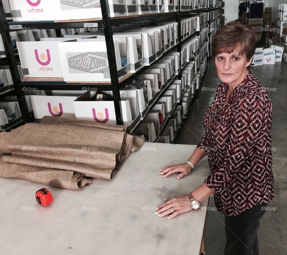 Portrait of woman standing in textile shop