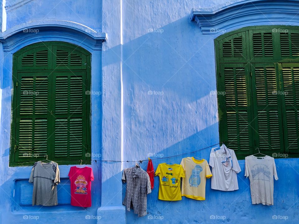 Hanging clothes on a blue wall