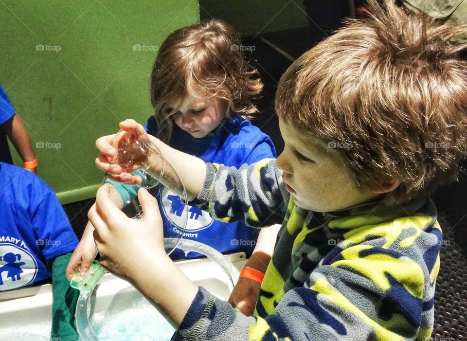 Playing With Soap Bubbles. Children Experimenting With Bubbles On A Kindergarten Field Trip