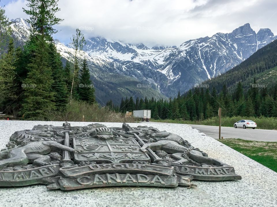 Canadian Rocky Mountains from historic commemorative spot on transcanada highway near the Alberta British Columbia border which includes a map of Canada on the marker 