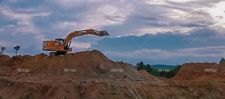 struggle to earn a living, a worker drives a western machine, on a sunny and peaceful evening