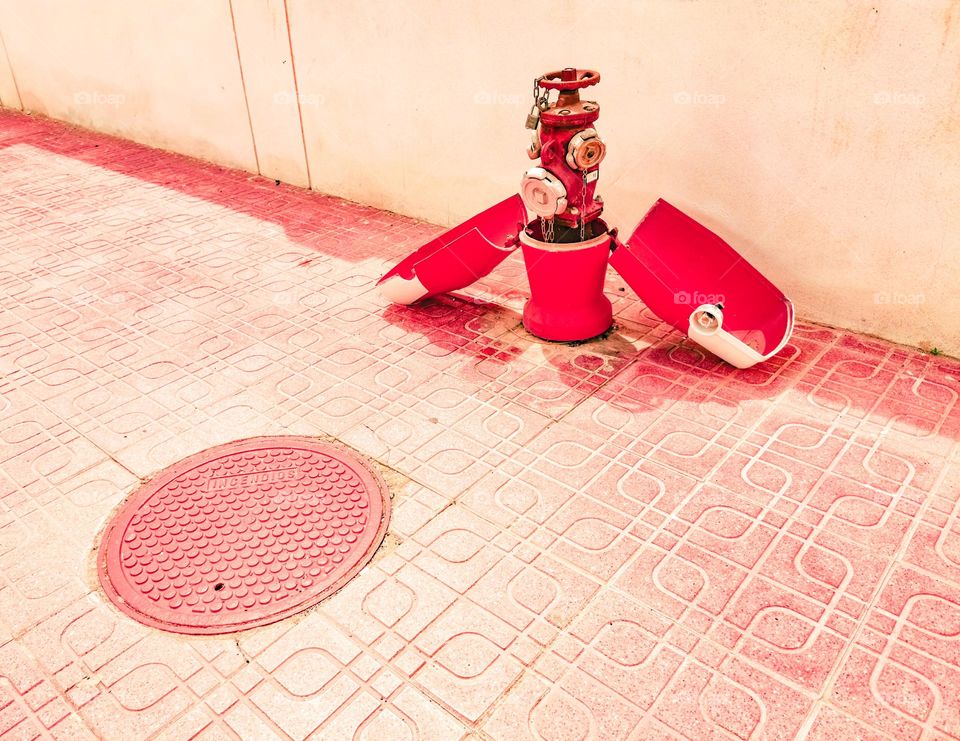 Open fire hydrant on a pavement