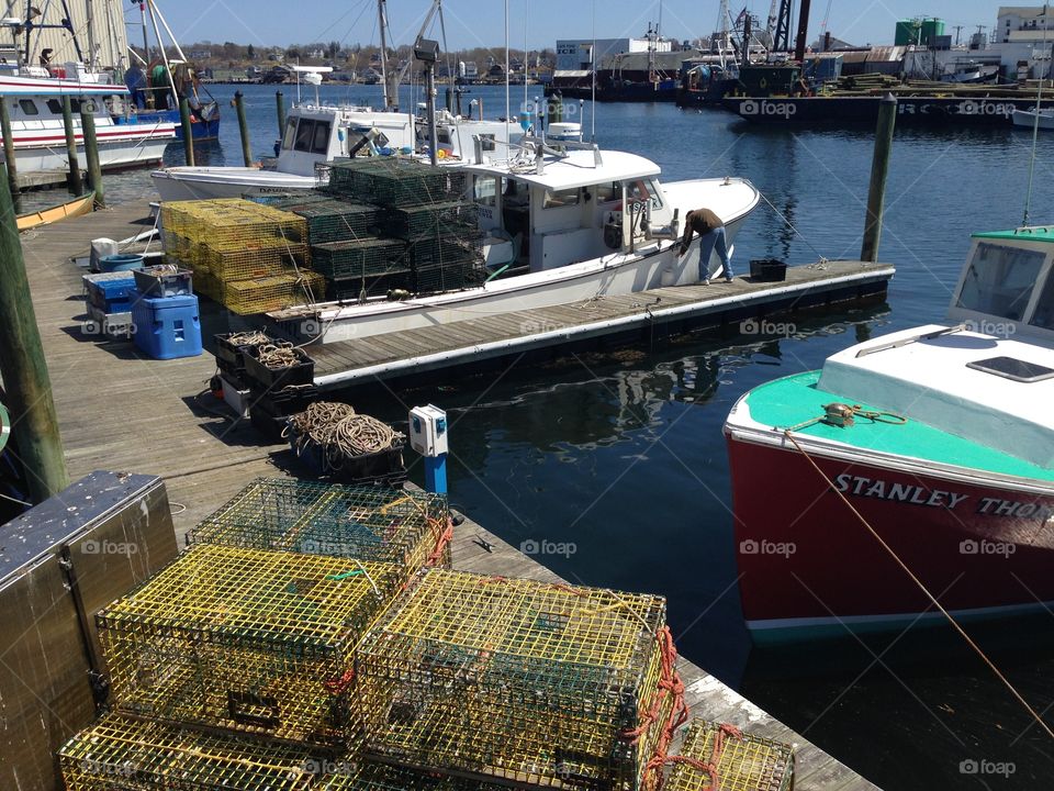 Harbor view. Deep sea boats parked waiting to be taken out to catch some lobster! Lobster traps all set up. Beautiful sunny day. 