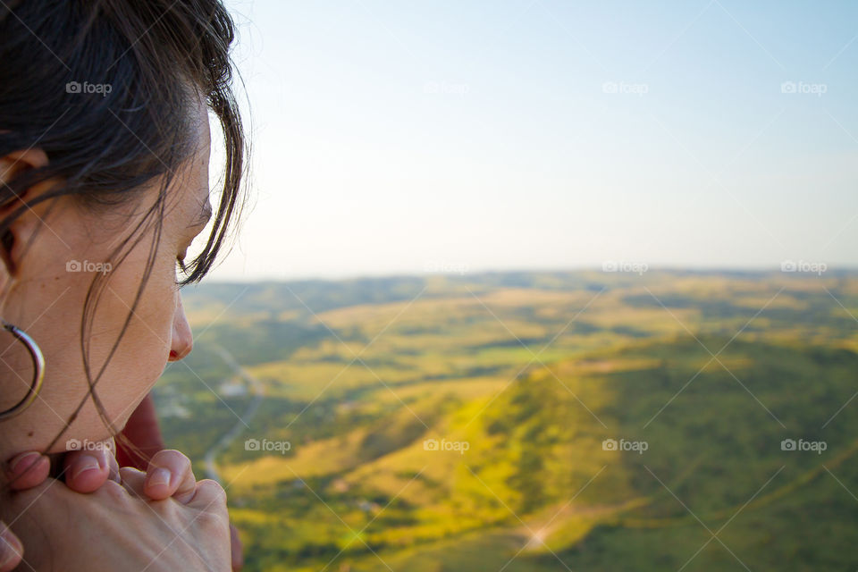 Memories - hot air balloon trip over Africa at sunrise. Woman taking in the beautiful scenery below.