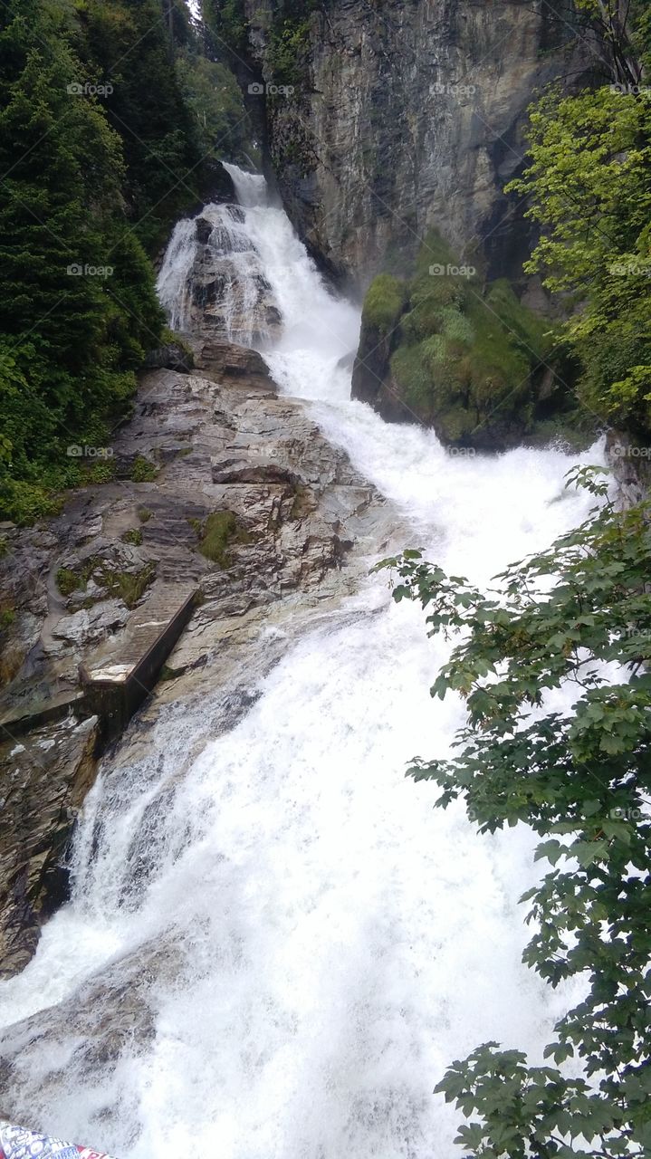 Bad Gastein, Austria, waterfall cascade at city, rock mountain, river, riverside