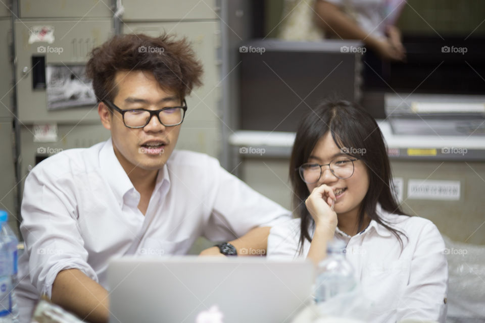 Friend looking at notebook