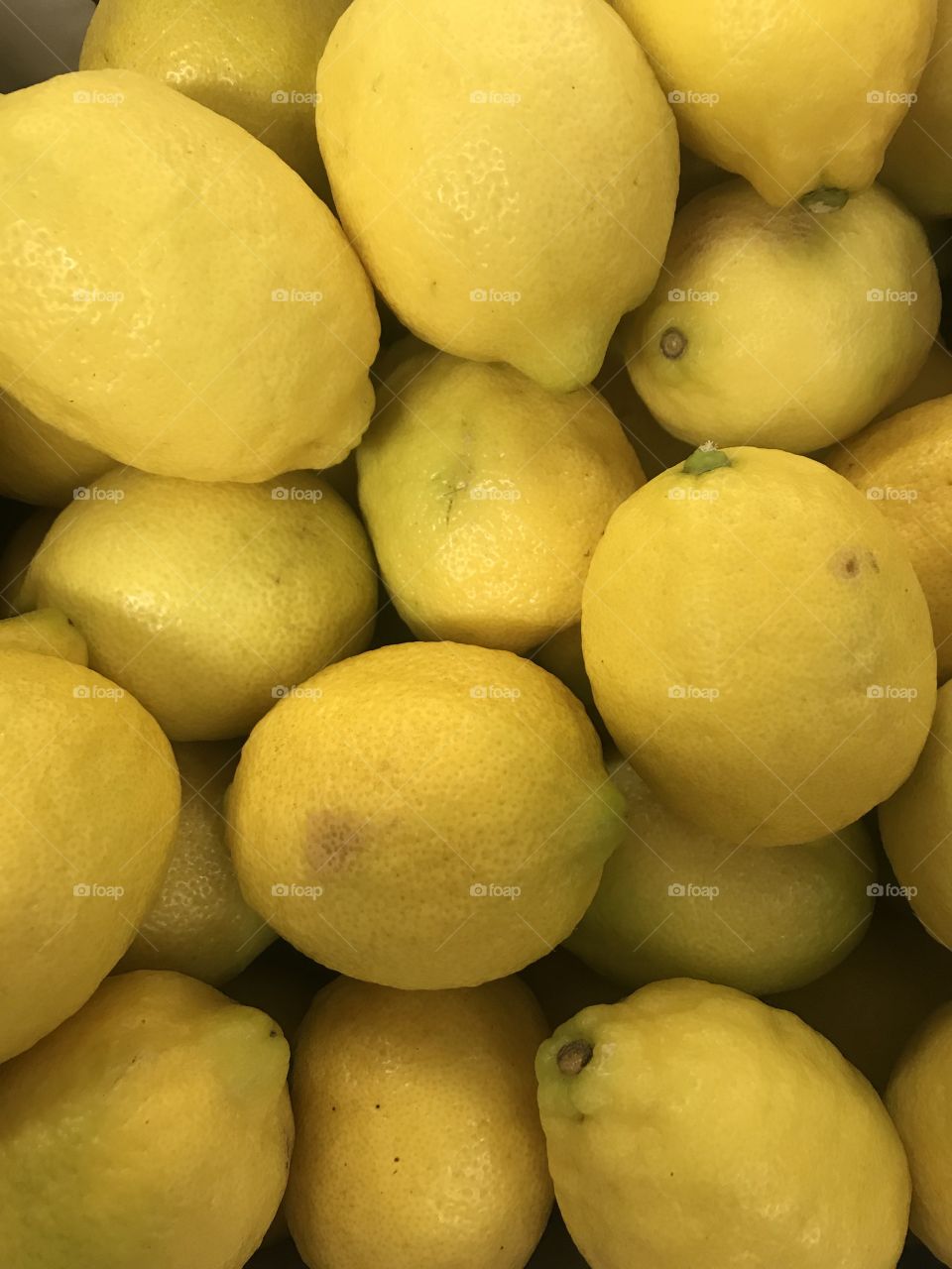 Close up of imperfect lemons in box. 