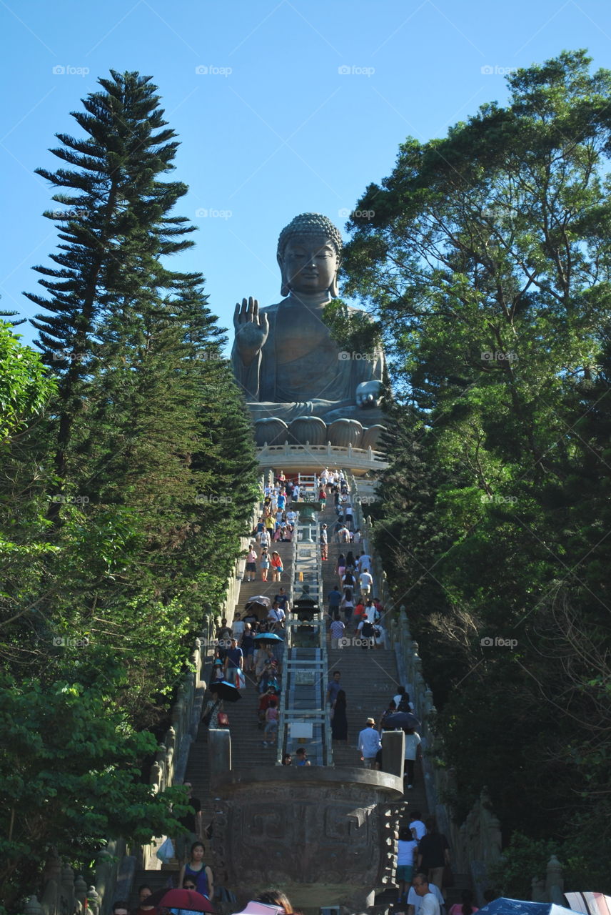 This is Tian Tan Buddha also known as the Big Buddha, is a large bronze statue of Buddha Shakyamuni, completed in 1993, and located at Ngong Ping, Lantau Island, in Hong Kong. The statue is sited near Po Lin Monastery and symbolises the harmonious relationship between man and nature, people and faith. It is a major centre of Buddhism in Hong Kong, and is also a popular tourist attraction. This picture was taken in June/19/2015  with the same camera that i had while me and my family were visiting this place .