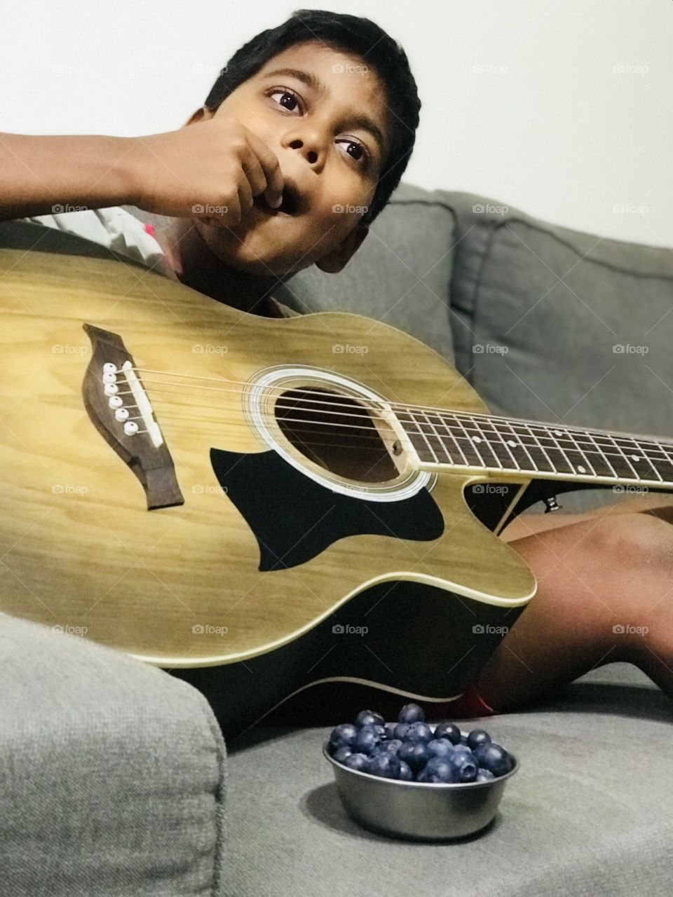 Eating Blueberries while playing guitar